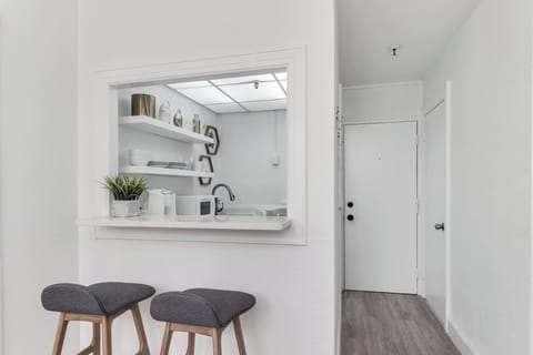 Large, fully stocked kitchenette. Countertops, microwave, 2 seater bar counter
