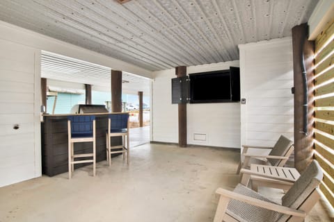 Outdoor area with built in grill area and TV