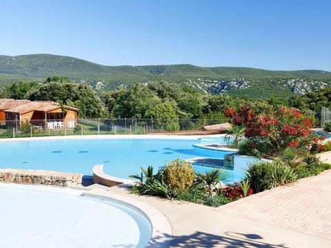 Water, Sky, Plant, Flower, Swimming Pool, Azure, Building, Outdoor Furniture, Tree, Natural Landscape