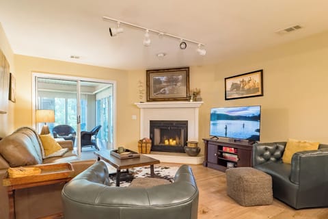 Relax in this bright, cozy living area, featuring leather seating, TV and games.