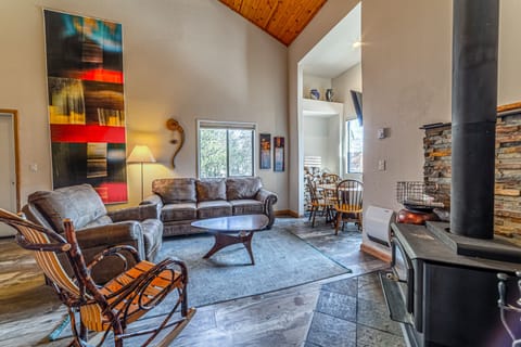 Open living area with vaulted ceilings and upgraded luxury vinyl flooring.
