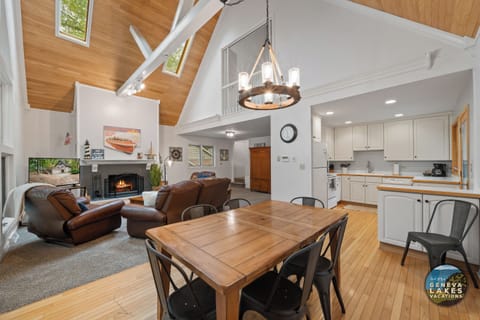 Open concept cathedral ceiling dining to living room. Smart TV & fireplace