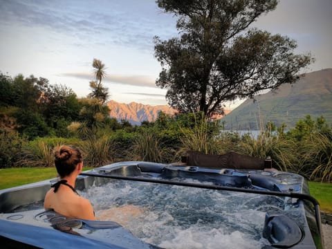 Relax in your private spa overlooking Lake Wakatipu and the Remarkables