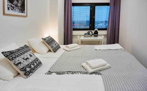 Hypo-allergenic bedding, desk, laptop workspace, blackout drapes