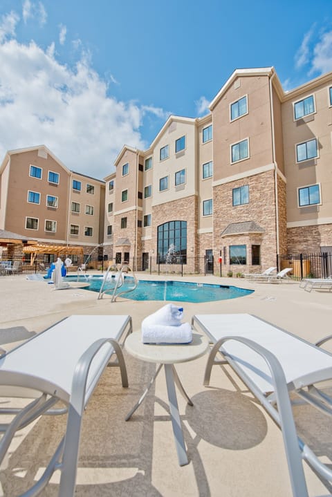 The outdoor pool area with lounge seating — wind down poolside after a day at Generation Park
