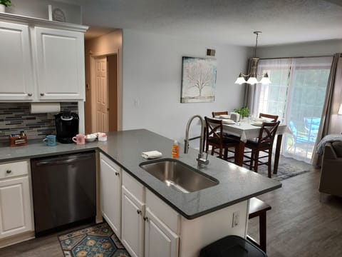 Open floor plan with 55" smart tv in living room and kitchen