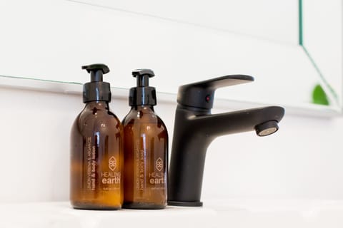 Deep soaking tub, rainfall showerhead, designer toiletries, hair dryer