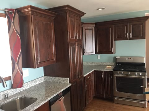 Kitchen with hands free faucet and granite counter top with island