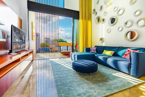 The large living area open onto the terrace with a view of 5th Avenue.