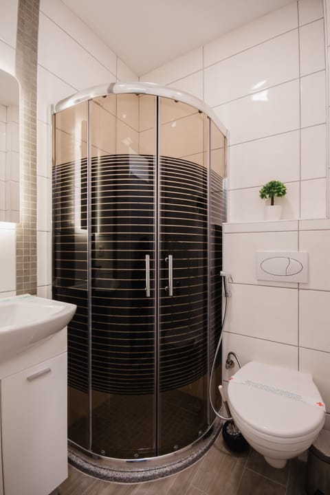 Shower, hair dryer, slippers, towels