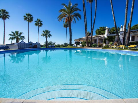 Water, Sky, Property, Swimming Pool, Azure, Tree, Blue, Leisure, Arecales, Outdoor Furniture