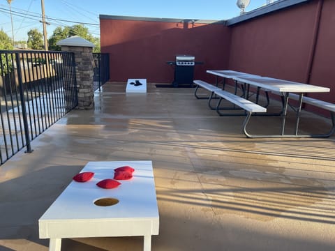  Gas barbecue grill, picnic tables, lounge chairs and a corn hole game