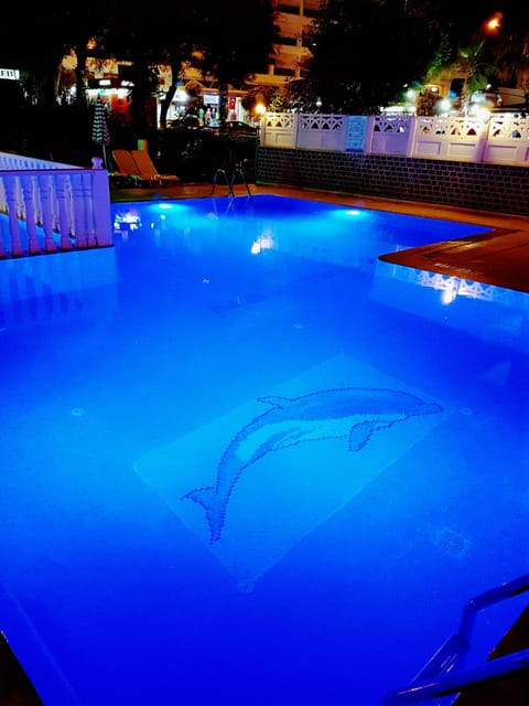 Seasonal outdoor pool, open 9:00 AM to 8:00 PM, pool umbrellas