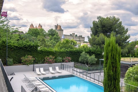 Seasonal outdoor pool, open 9:00 AM to 8:30 PM, pool umbrellas