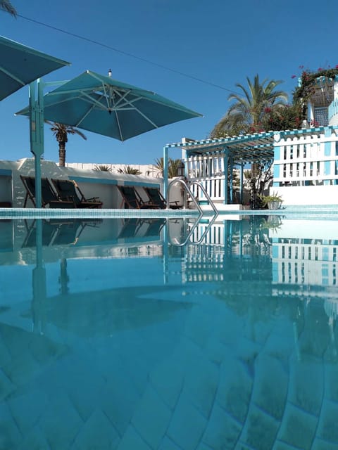 Seasonal outdoor pool, open 10:00 AM to 6:00 PM, pool umbrellas