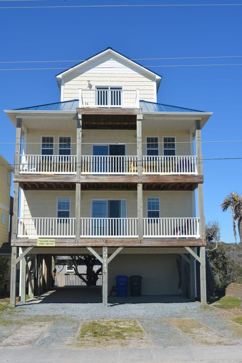 House view from the dunes. Three ocean facing decks with chairs. 
