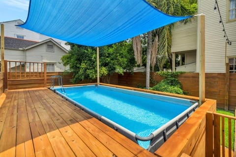 Sparkling outdoor pool on a spacious wooden deck — your private backyard escape.
