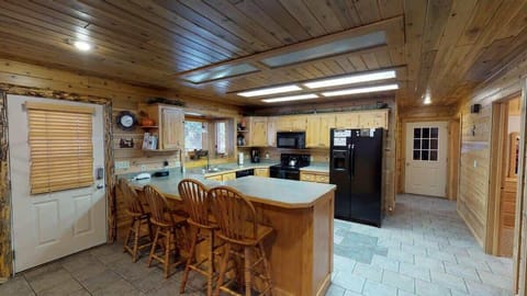Kitchen has bar for added seating and counter space.