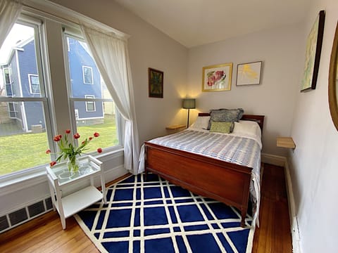 Bedroom 1 is bright and cherry; sleeps up to two people.