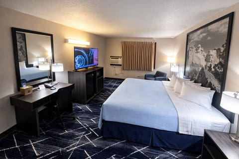 Premium bedding, desk, laptop workspace, blackout drapes