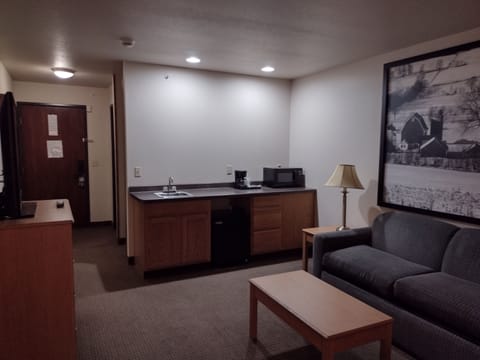 Suite, 1 King Bed, Refrigerator | Living area | TV