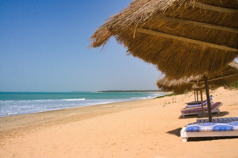 On the beach, white sand, sun loungers, beach umbrellas