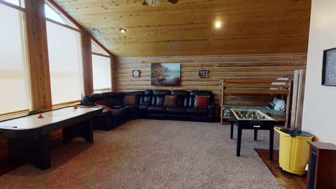 Upstairs loft is equipped with sectional couch, satellite tv, and foosball table.