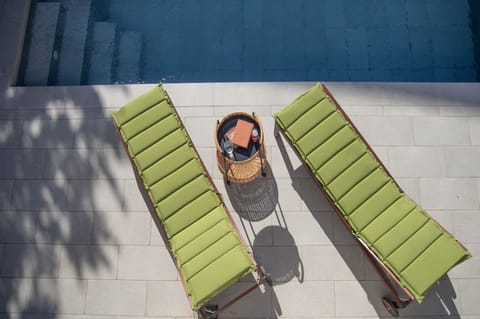 Sunbeds by swimming pool