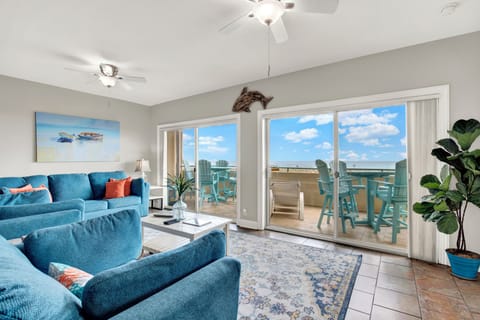 Huge living area with two sliding doors leading to the expansive balcony.