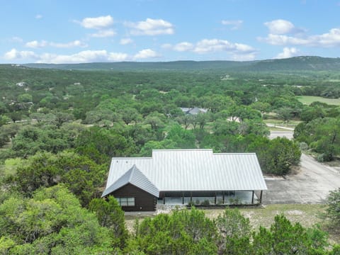 Cozy retreat nestled among rolling hills and lush greenery, offering a peaceful escape surrounded by natural landscape and scenic views in all directions.