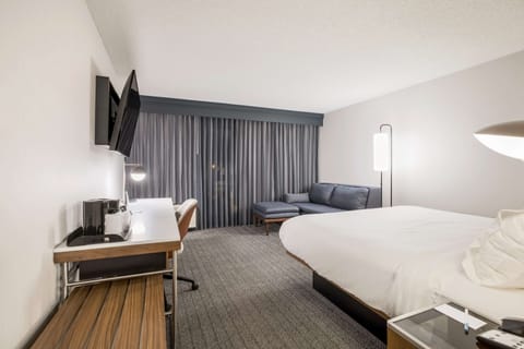 Premium bedding, desk, laptop workspace, blackout drapes