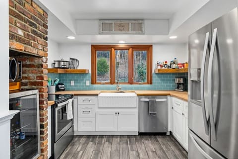 Fully stocked kitchen with mixer, drip coffee pot, blender, crock pot, pots and pans