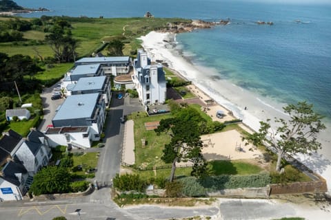 This beachfront residence looks straight out over the sea, just past the grassy grounds.
