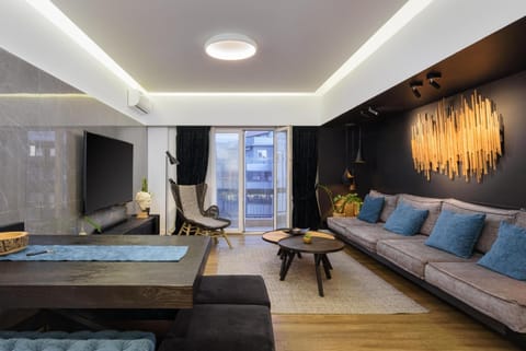 Exclusive Apartment, 4 Bedrooms | Living area | 70-inch flat-screen TV with cable channels, Smart TV, Netflix