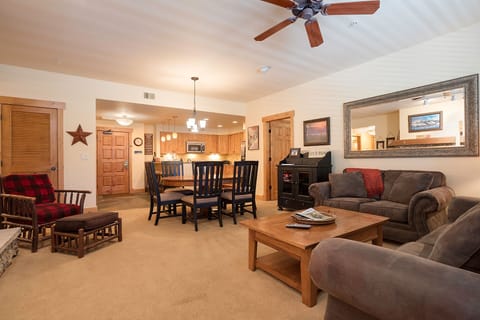 Relax in your spacious living area with plush seating, rustic wood touches, and open-concept kitchen perfect for memorable gatherings.