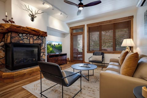 Cozy up by your stone fireplace while soft leather seating and rustic wood beams create the perfect mountain retreat atmosphere.