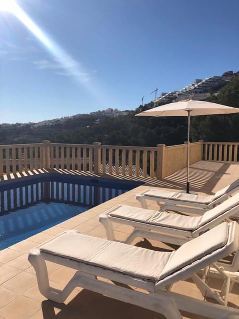 Terrace overlooking pool and mountainside with ample room for eight sunbeds