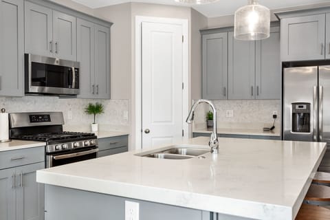 Fully stocked gourmet kitchen featuring granite countertops