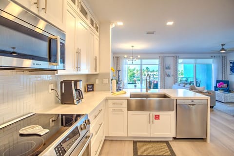 1st Flr Kitchen open to living room, view of pool and water