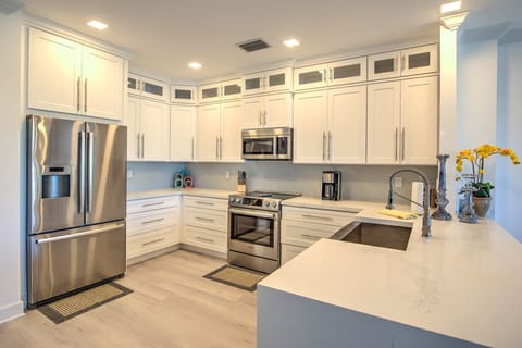 1st Flr Kitchen open to living room, view of pool and water