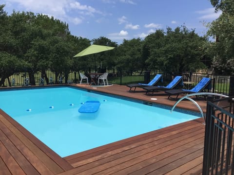 Large 16x32 swimming pool with seating in the sun and shade.