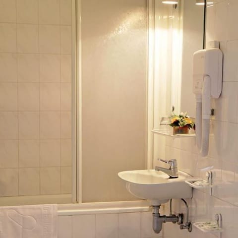 Deep soaking tub, rainfall showerhead, designer toiletries, bidet