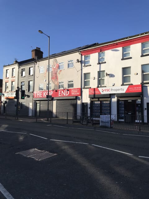 Frontage to property entrance grey door between FSC property and The Kop End Bar