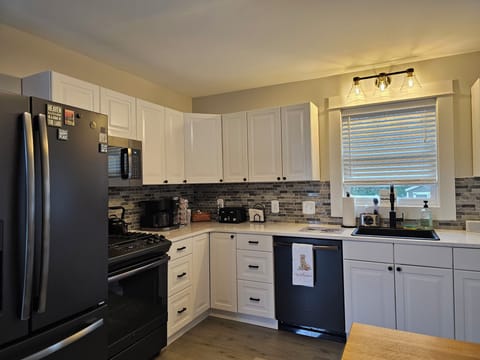 Newly redone kitchen with quartz countertops