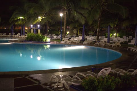 Outdoor pool, pool umbrellas, lifeguards on site