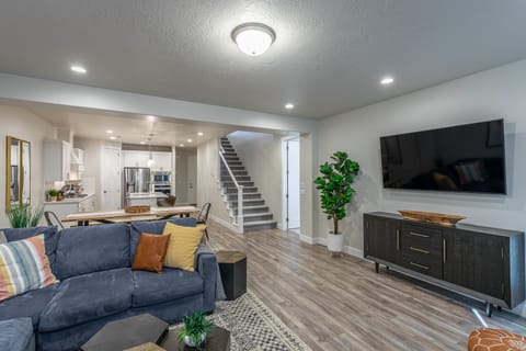 Living Room View - The living room is designed as an open floor plan and is a great gathering place for meals, games, or watching TV during your stay.