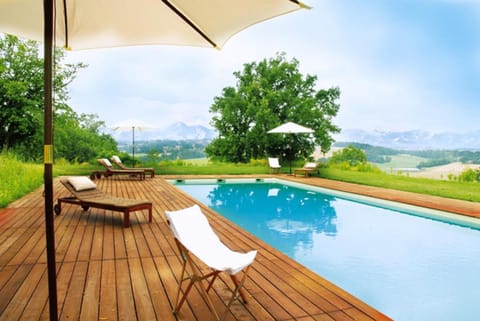 Seasonal outdoor pool, a natural pool, pool umbrellas, sun loungers