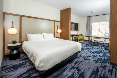 Desk, laptop workspace, iron/ironing board, bed sheets