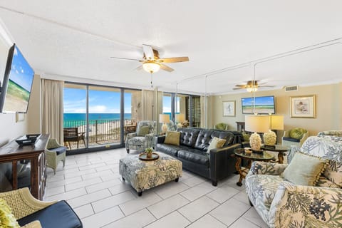 This bright gulf-front living room is a comfortable place to relax and enjoy the spectacular beach and water views. Filled with natural light, the space features a sofa sleeper, twin recliners, and a Smart TV, making it perfect for lounging, movie nights, 