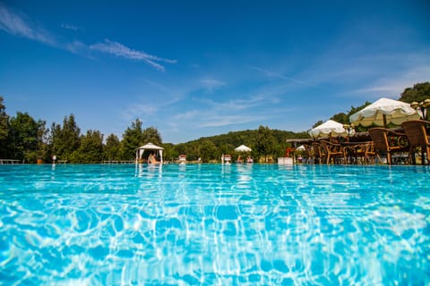 Seasonal outdoor pool, open 9:00 AM to 7:00 PM, pool umbrellas